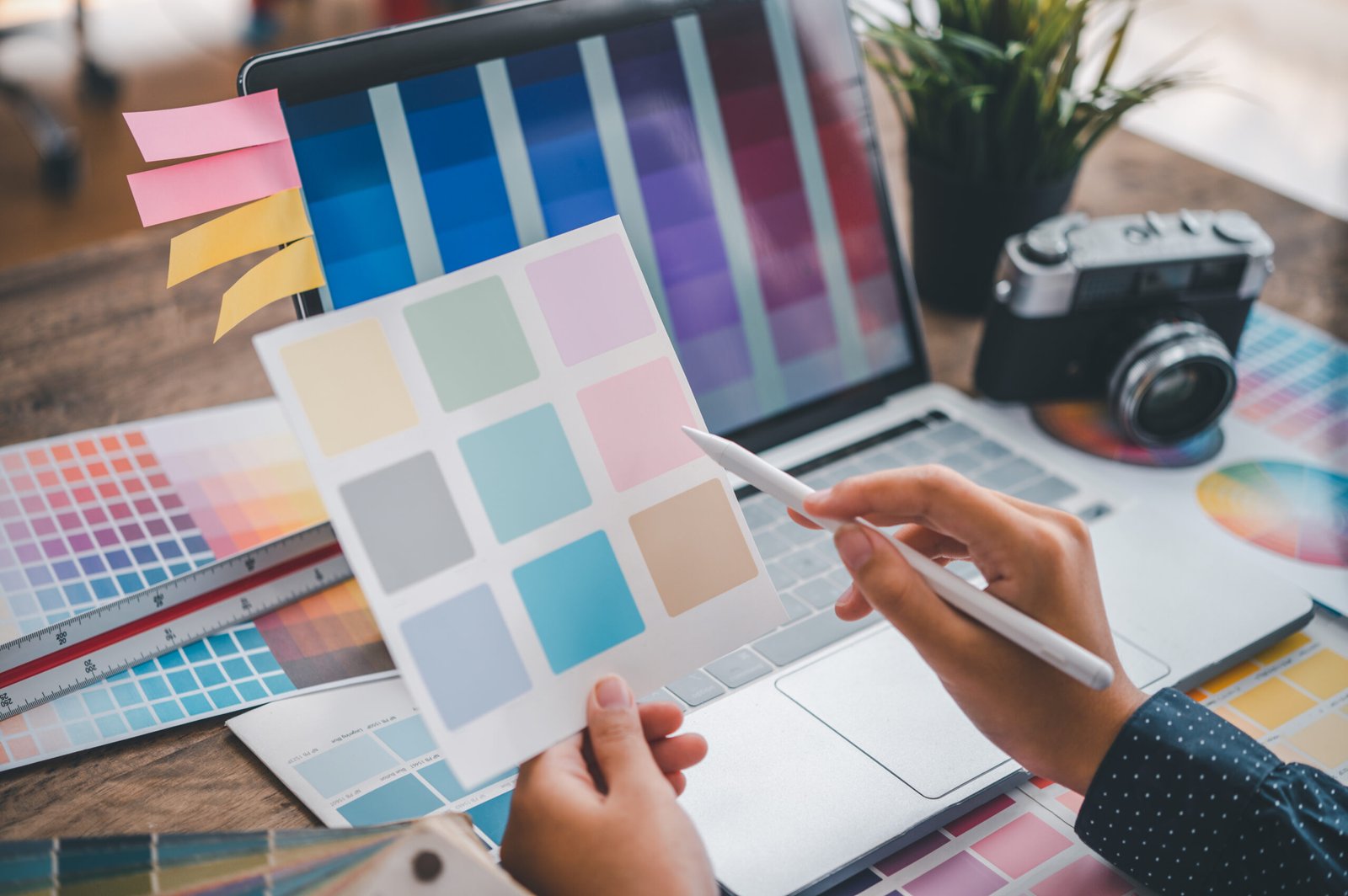 Graphic designer architects who work with laptops and color comparison tables for design work.