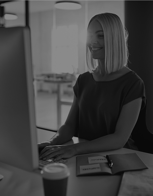 smiling-businesswoman-working-at-her-office-desk-i-2026-03-09-06-36-43-utc 1 1