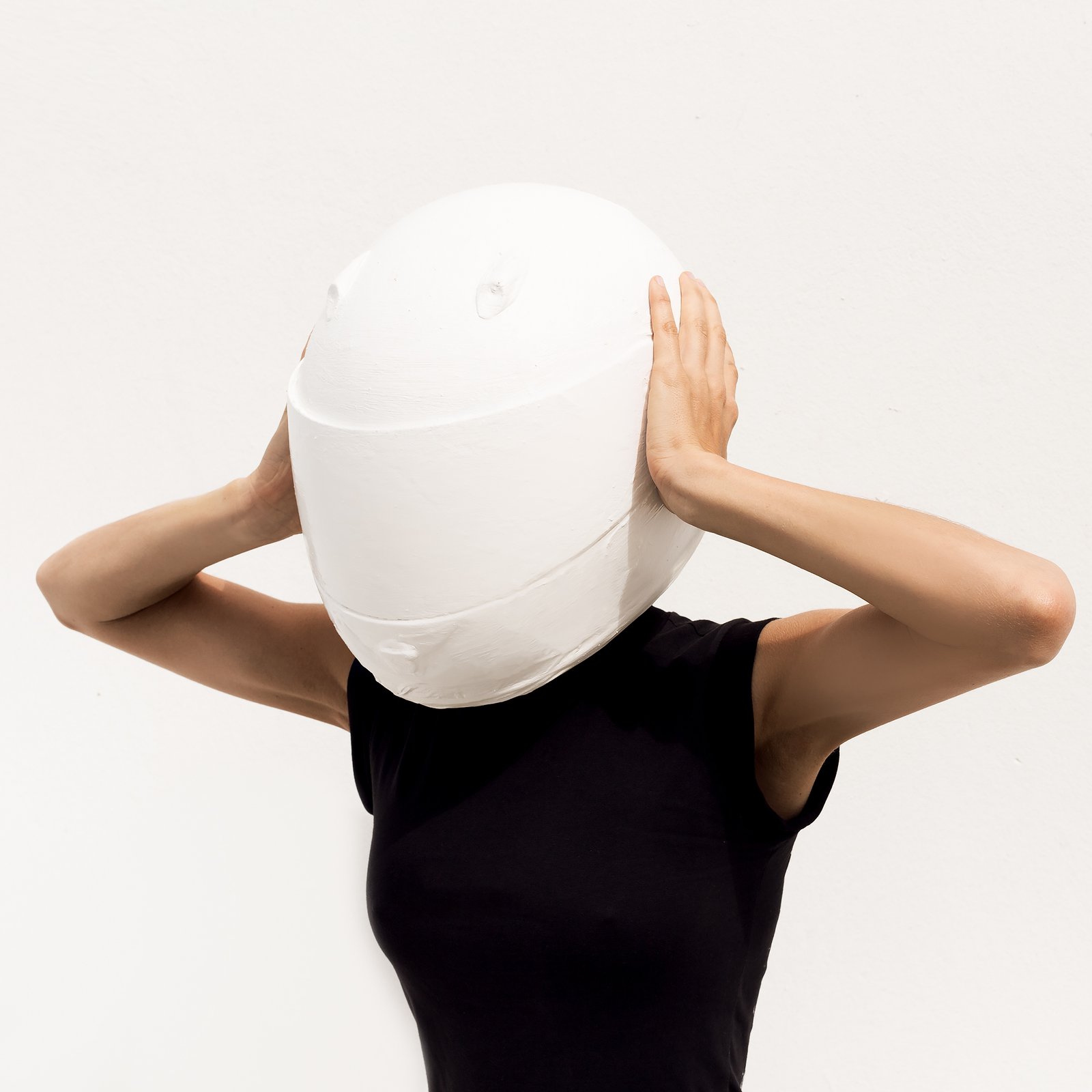 Model in the helmet. Minimal art fashion.